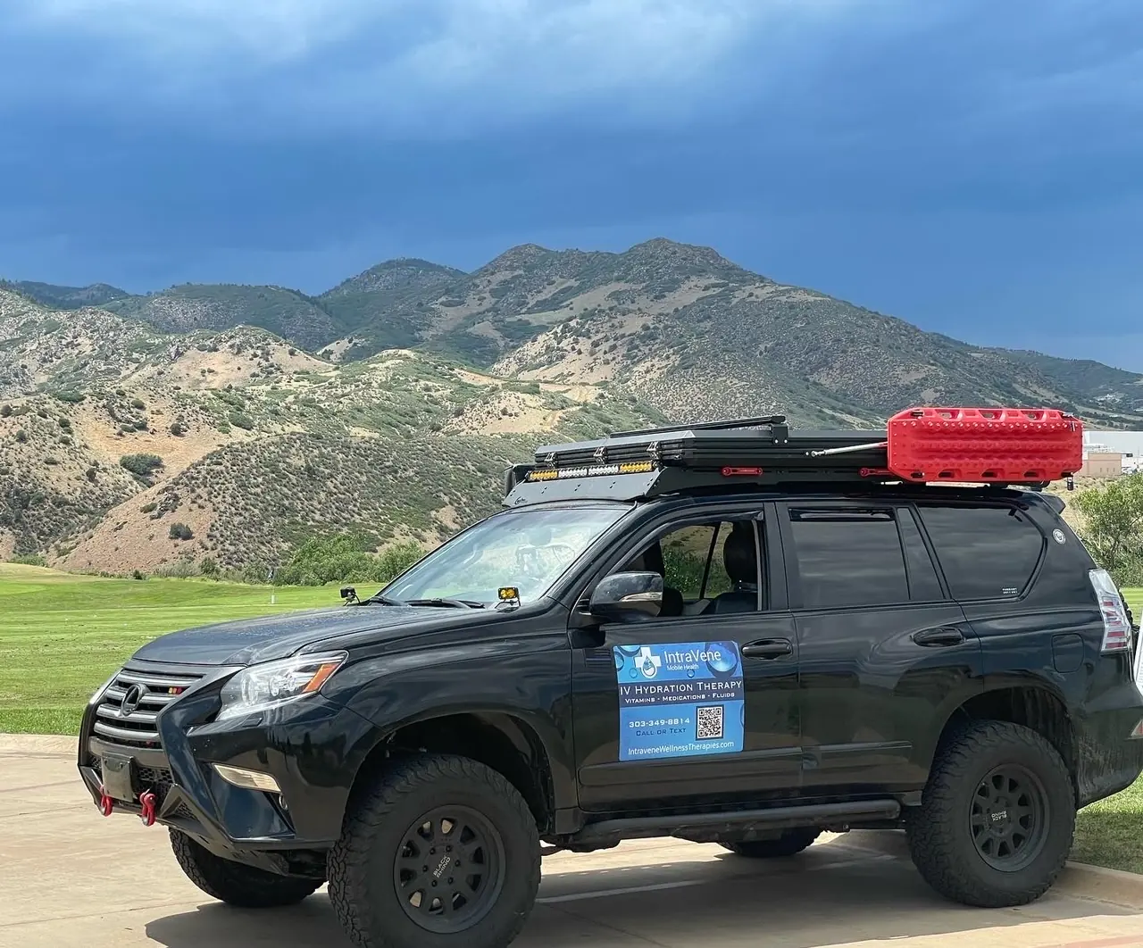A mobile IV therapy vehicle parked below the Colorado foothills near Denver